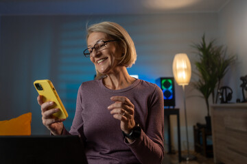 Poster - Cheerful woman reading messages on phone at home