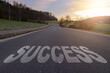 Success text written on road concept for business planning strategies and challenges or career path opportunities and change, road to success concept, Success word on street.