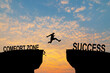 Businessman or worker jumping from Comfort zone to be Success. Business concept with sunset background.