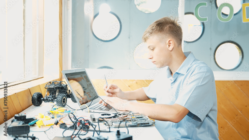 Caucasian boy fixing main board while study construction by using ...