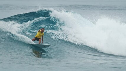 Poster - Surfer rides the wave in the Maldives