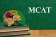  MCAT message with model brain with anatomy on books