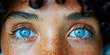 illustration of portait cut out with close up on blue eyes and dark hair, tanned skin with freckles