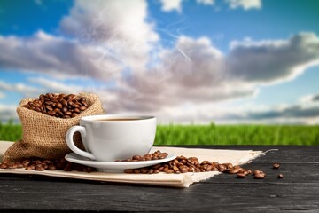 Wall Mural - Cup of hot aroma coffee with roasted beans