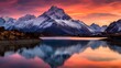 Panoramic view of snowcapped mountain range reflected in lake at sunset