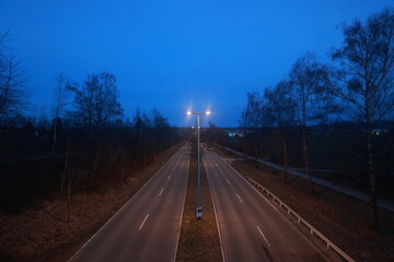 A road with two lanes and a street light in the middle