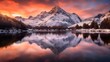 Panoramic view of snow covered mountain range reflected in calm lake.