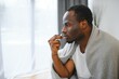 © Serhii - Cold And Flu Treatment. Sick African American Man Using Nasal Spray