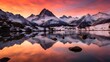 Panoramic view of snow-capped mountain range and lake at sunset