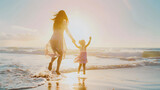 Fototapeta Zwierzęta - mother with her daughter on the beach shore in a beautiful sunset symbolizing mother's love