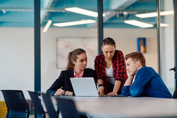 a team of successful programmers sits in a startup office, strategizing new business projects and so