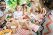 © Daniel Gonzalez/Stocksy - Crop friends smiling and having lunch