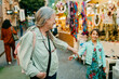 © Jimena Roquero/Stocksy - Grandmother and granddaughter having fun in street market