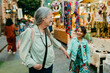 © Jimena Roquero/Stocksy - Grandmother and granddaughter having fun in street market