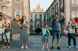 © Jimena Roquero/Stocksy - Group of tourists taking pictures on their smartphones