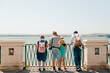 © Jimena Roquero/Stocksy - Tourist in front of panoramic view of the sea
