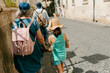 © Jimena Roquero/Stocksy - People walking on the sidewalk of an old Italian City.