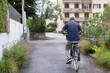 © Anna Berkut/Stocksy - rear view of elderly man on bicycle, senior riding bike on street