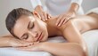 © cd - woman receiving a back massage Close-up of a beautiful young woman with closed eyes relaxing on massage spa treatment on a blurred bright salon background with copy space created with generative ai