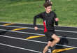 © Melanie DeFazio/Stocksy - Highschool boy running track