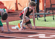 © Melanie DeFazio/Stocksy - Highschool boy running track