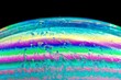 © James Fulton/Stocksy - A macro view of a bubble creating a colourful pattern