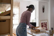 © Milles Studio/Stocksy - Black woman packing goods in box for delivery