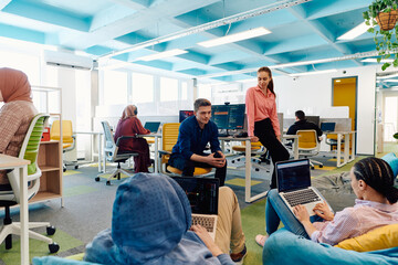 In a modern startup office, a diverse group of young and capable businesspeople engage in lively discussions about various projects, showcasing teamwork, innovation, and entrepreneurial spirit