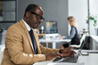 © Clique Images/Stocksy - Mature Black Businessman Using Laptop