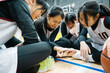 © ZQZ Studio/Stocksy - Teenager girls sitting on floor in gym