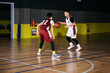 © ZQZ Studio/Stocksy - Rivalry on basketball field between teenagers