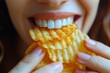 Person eating delicious potato chips. Close up of mouth eat potato chips.