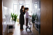 © Oleksii Syrotkin/Stocksy - Mom daughter getting ready morning rituals togetherness