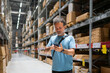 © Hernandez & Sorokina/Stocksy - Man Using Cellphone In Warehouse