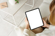 © DZ FILM/Stocksy - A tablet with a white screen in women's hands