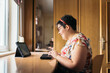 © Santi Nuñez/Stocksy - Handicapped woman using laptop