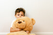 © Lea Jones/Stocksy - little boy playing with big teddy bear