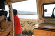 © Luis Herrera/Stocksy - woman enjoying nature traveling in camper van