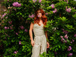© Iryna Shepetko/Stocksy - Young red-haired girl in a bush of flowers
