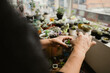 © Felipe Barrera/Stocksy - Woman taking care of her plants