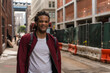 © Luis Velasco/Stocksy - Happy Man Walking On The Streets Of An Industrial Area In New York.