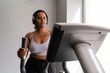 © Hernandez & Sorokina/Stocksy - Curvy Indian Woman Using Elliptical Trainer