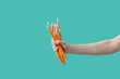 © Yaroslav Danylchenko/Stocksy - Woman's hand holding bundle of pencils.