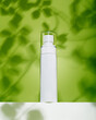 © Spencer Nguyen/Stocksy - White cosmetic bottle under sunlight