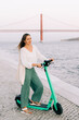 © Olga Moreira/Stocksy - Woman on electric scooter