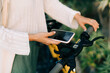 © Olga Moreira/Stocksy - Woman renting electric scooter using her phone