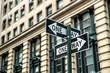 © David Prado/Stocksy - One way road signs on street near building in daylight