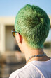 © Luciano Spinelli/Stocksy - The back of an anonymous young man with green hair