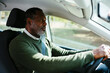 © BONNINSTUDIO/Stocksy - Cheerful mature man driving car