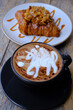 mocha with caramel  almond croissant on the table
